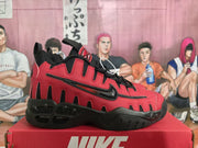 Side profile of red and black Nike sneakers with oversized lettering