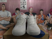 Front view of white ASICS basketball sneakers with perforated toe panels