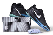 Black and blue Nike Sabrina 4 shoes posed on a shoe box