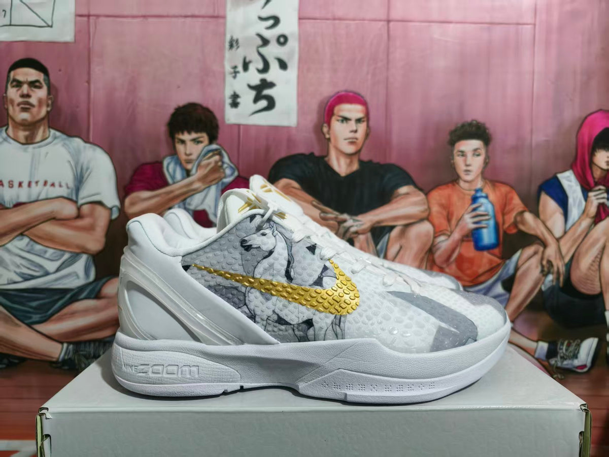 Side view of white Nike Zoom basketball sneakers with gray patterned panels and a gold Swoosh on a shoe box.