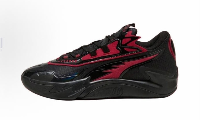 Side view of black low-top sneakers with red accents, layered side panels and a sculpted black outsole.