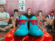 Front view of blue Nike basketball sneakers showing red laces, textured uppers, and matching tongue branding.