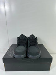 Front view of dark grey and black low-top sneakers with black laces