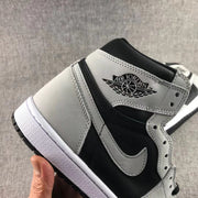 Close-up of the grey side overlay, black side panel, and Air Jordan wing branding.