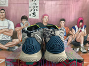Rear view of the Nike basketball sneakers showing dark blue heel panels, patterned collars, and cream-colored outsoles.