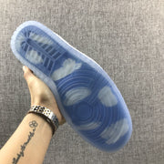 Underside view showing the translucent blue outsole with circular and segmented traction patterns.