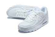 Angled top view of white Nike Air Max 90 sneakers.