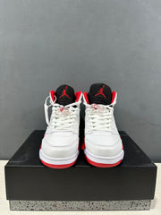Front view of the pair showing white toe boxes, white laces, black tongues, and red tongue logos.