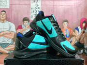 Pair of black and turquoise basketball sneakers shown from the side