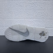 Underside view of the white sneaker outsole.