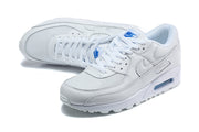 Pair of white Nike Air Max 90 sneakers in an angled top view.