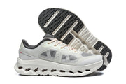 White and gray On Cloudtilt Remix sneakers shown with the outsole visible.