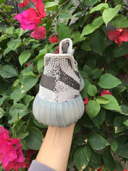 Rear view showing the knit heel panels, padded collars, and rounded translucent heel sections.