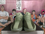 Front view of the green Nike basketball sneakers showing the padded collars, textured laces, and layered side panels.