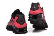 Rear and underside views of black and pink sneakers.