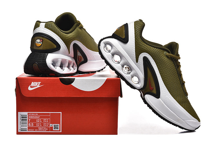 Olive green Nike Air Max DN sneakers displayed with a red shoe box; the box label shows size details.