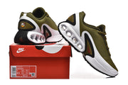 Olive green Nike Air Max DN sneakers displayed with a red shoe box; the box label shows size details.