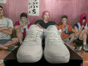 Front view of the silver and white Nike basketball sneakers showing the laces, padded tongues, and textured toe areas.