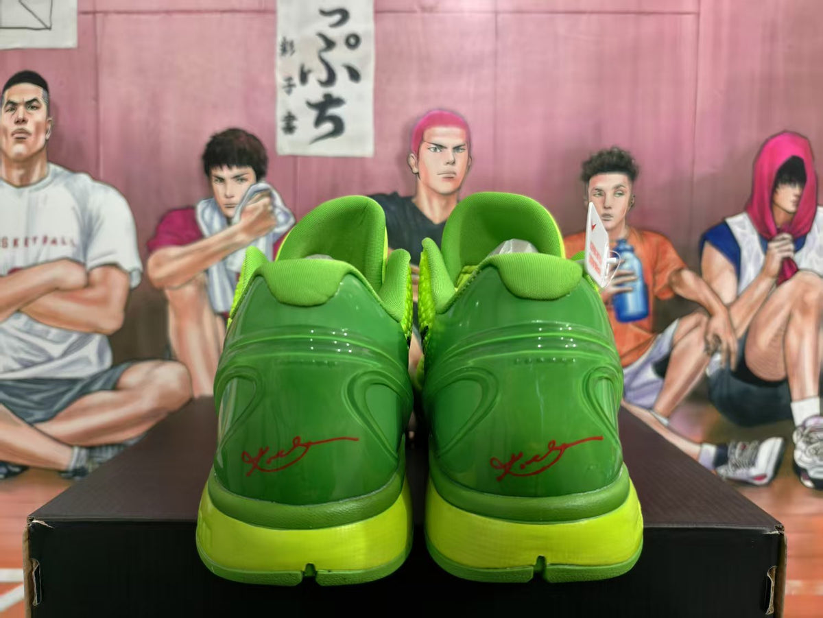 Rear view of lime green Nike basketball sneakers showing darker green heel panels, bright midsoles, and red heel detailing.