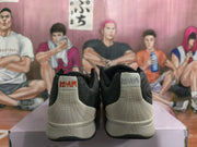 Rear view of the gray Nike sneakers showing heel panels, stitched lines, and contrasting heel branding.