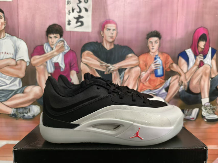 Side view of a black and white Jordan basketball sneaker with a white midsole and red Jumpman accent.