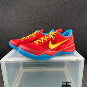 Pair of red Nike basketball sneakers displayed together, showing yellow laces, yellow Swoosh branding, blue lining, and blue outsoles.
