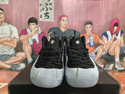 Front view of a pair of white and black high-top sneakers.
