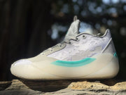 Side view of gray and lavender Jordan 39 sneakers with teal midsole accents.