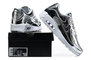 Nike Air Max 90 QS silver and black sneakers displayed on a box with the label visible.