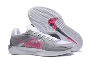 Basketball shoes shown from the side and underside, with a patterned outsole and pink accents.