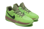 Pair of bright green Nike basketball shoes with olive tongues and laces, viewed from the front quarter.