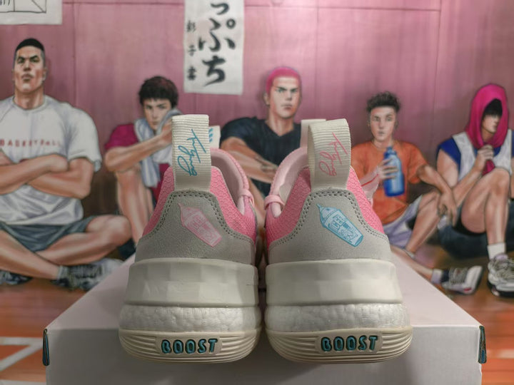 Rear view of pink and light grey Adidas sneakers showing heel details, pull tabs and BOOST lettering on the soles.