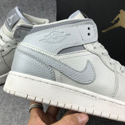 Close-up of the side Swoosh, Jordan Wings panel, textured upper, and stitching.