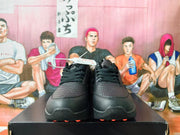Front view of black lace-up Nike sneakers with perforated toe panels