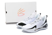 White and black basketball sneakers displayed beside a white shoe box.