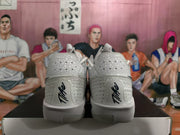 Rear view of white Nike sneakers with perforated heel panels, black heel branding, and red accents visible at the sides.
