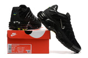 Pair of black Nike Air Max Plus sneakers on a red Nike shoe box; the box label shows style code FZ2591-001 and sample sizes.