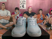 Front view of pale blue Nike basketball sneakers showing the laces, tongue branding, textured toe panels, and light-colored outsoles.
