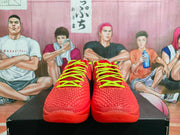 Front view of paired red basketball sneakers with textured uppers and bright neon green laces.