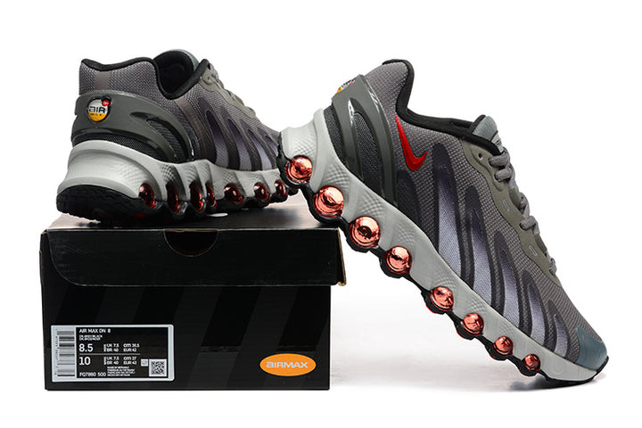Gray Nike Air Max DN sneakers displayed with a shoe box; the box label shows a sample size.