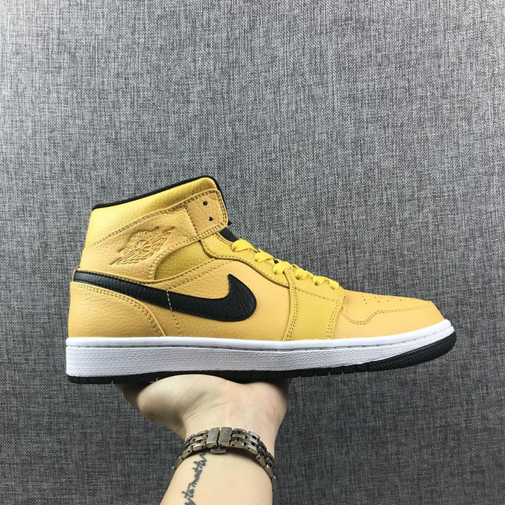 Side profile of a yellow Air Jordan 1 Mid sneaker with a black Swoosh, white midsole, and black outsole.