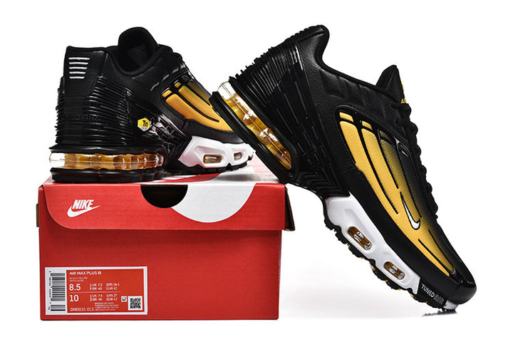 Black and yellow Nike Air Max Plus III sneakers displayed with a red shoe box.