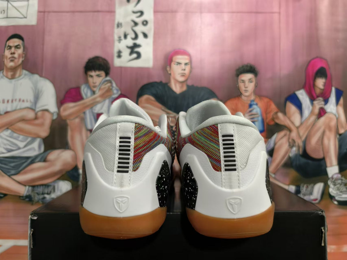 Rear view of white basketball shoes with patterned panels and gum-colored outsoles