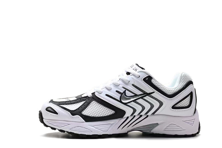 Side view of a white and black Nike mesh running-style sneaker with layered panels and a sculpted sole