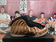 Side view of bronze and black high-top sneakers with a sculpted molded upper and translucent outsole.