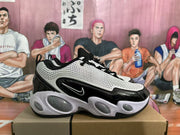 Side profile showing the perforated upper, black overlays, side swoosh, and sculpted sole.