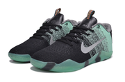 Pair of mint green and black low-top basketball shoes, front three-quarter view