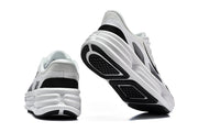 Rear and outsole views of white Nike sneakers with black details