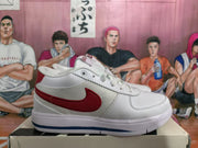 Side profile of a white sneaker with a red Nike swoosh, white upper, and blue outsole stripe.