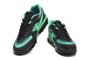 Top and front views of black and mint-green Nike Air Max sneakers.